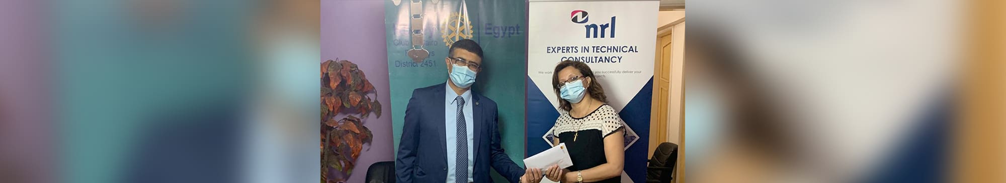 A picture of Hazem and a lady in Egypt - both wearing facemasks