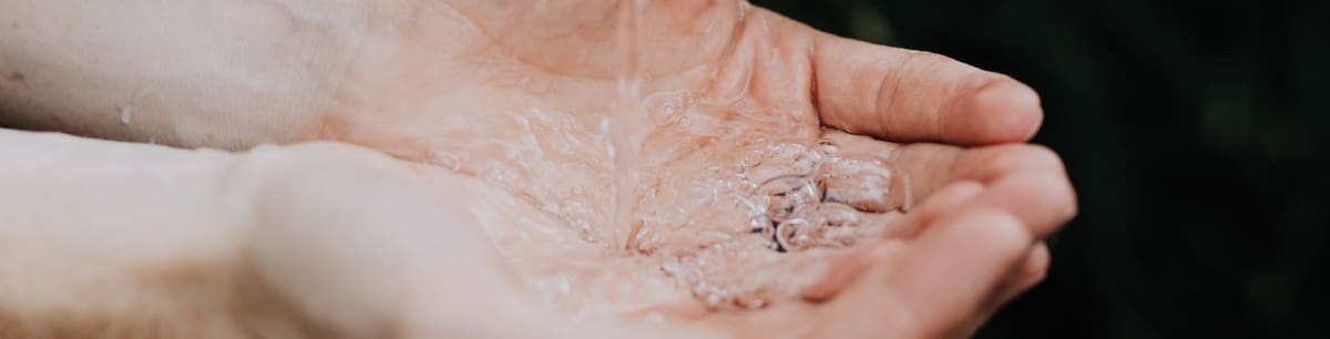 a picture of someone's hands holding water