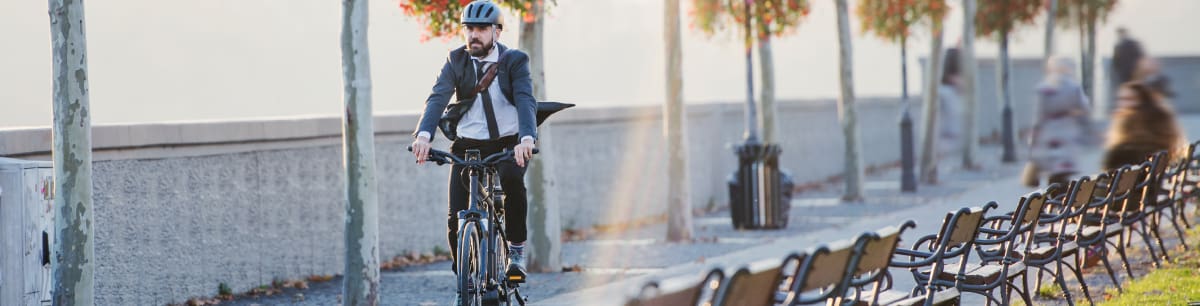 A picture of a young business man riding his bike to work