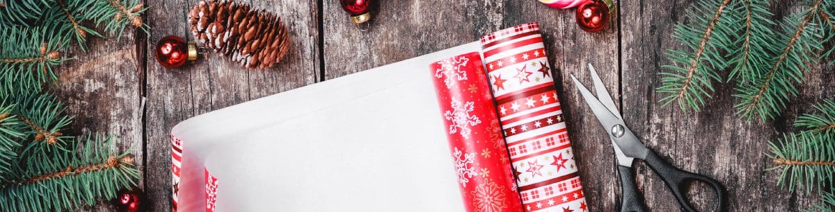 Christmas wrapping paper and scissors on a table