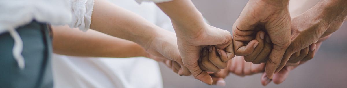 a group of hands doing a fist bump in a circle