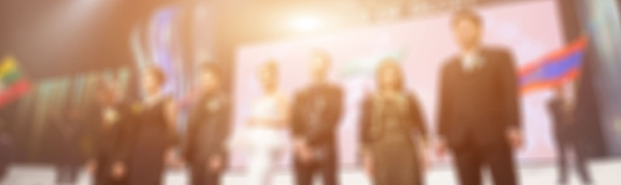 A blurred image of a business award ceremony