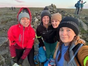 Sunderland colleagues in coats and bobble hats taking a selfie after completing the 3 Peaks Challenge.