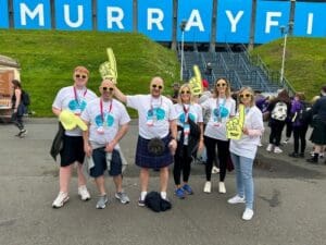 The Falkirk team at the Kiltwalk, wearing yellow foam hands and matching yellow charity tops.
