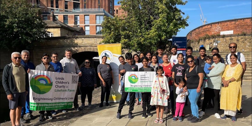 Srivalli and friends stood with the Leeds Children's Charity banner