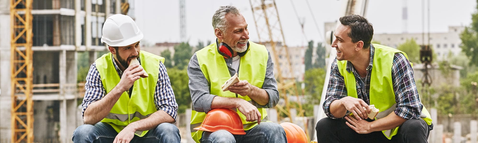 group of contractors all sat eating and chatting