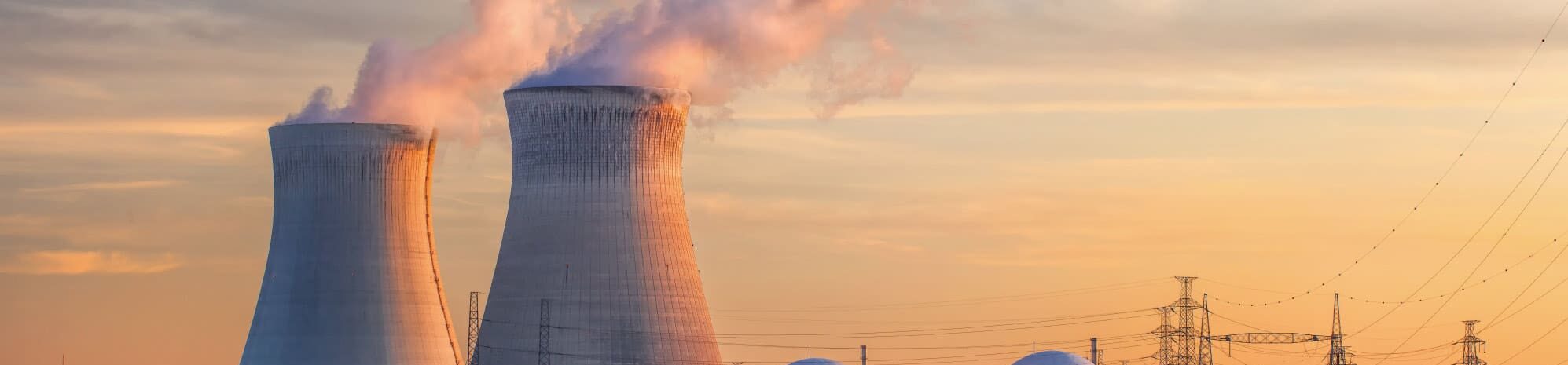 Nuclear cooling towers against a sunset background