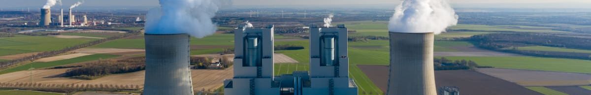 A picture of nuclear cooling towers with steam billowing out