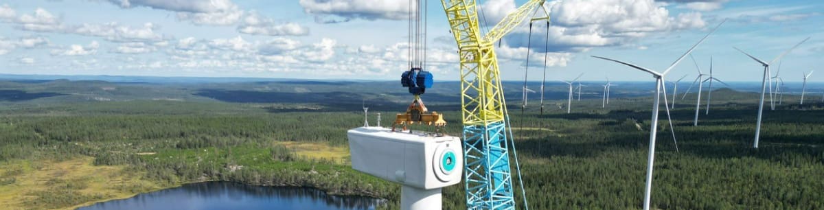 View from the top of an MCE wind turbine under construction, overlooking a green landscape.